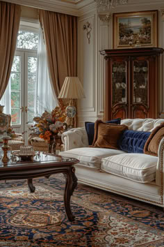 a living room filled with lots of furniture next to a window covered in drapes