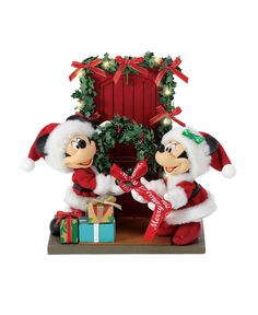 two mickey and minnie mouse christmas figurines with presents