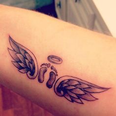 a close up of a person's arm with an angel tattoo design on it