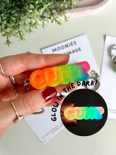 glow in the dark keychain is being held up by someone's hand