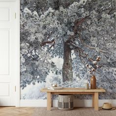 a room with a bench and wallpaper that has a large tree in the background