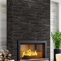 a fire place in the middle of a living room with wood logs on the floor