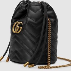 Nwt Authentic Gucci Gg Marmont Mini Bucket Bag A Mini A Mini Bucket Bag Shape In Black Matelass Leather With A Double G Decorates The Front. Featuring A Chain Strap And Drawstring Closure The Versatile Shape Can Also Be Worn As A Cross Body Bag. Black Matelass Chevron Leather With A Heart On The Back Antique Gold-Toned Hardware Moir And Microfiber Lining With Suede Like Finish Detachable Key Ring 2 Card Slots Chain Strap With 23.6" Drop Drawstring Closure 5.5"W X 6.7"H X 5.1"D Made In Italy Gg Marmont Mini Bucket Bag, Gucci Bucket Bag, Gucci Gg Marmont Mini, Gg Marmont Mini, Gucci Mini, Mini Bucket Bags, Elegant Bags, Gucci Gg Marmont, Gg Marmont