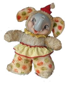 a stuffed animal that is wearing a dress