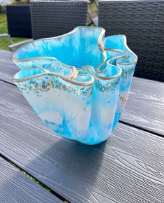 two blue and white vases sitting on top of a wooden table next to each other