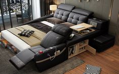 a black leather reclining bed in a bedroom next to a zebra footstool