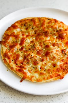 a cheese pizza sitting on top of a white plate