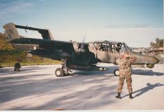 a man standing in front of an airplane