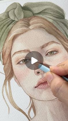 a person is drawing a woman's face with watercolor pencils on paper