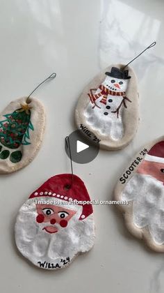 three ornaments with santa claus and snowman on them