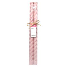 two pink candles wrapped in twine and tied with rope