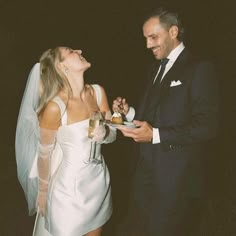 a man in a tuxedo and a woman in a wedding dress are laughing