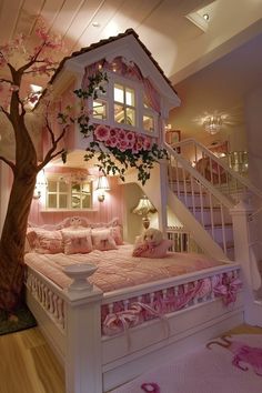 a doll house bed with pink bedspread and flowers on the comforter is next to a tree