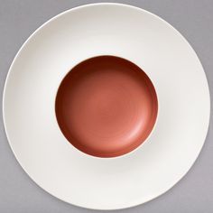 a white plate with a red center on it