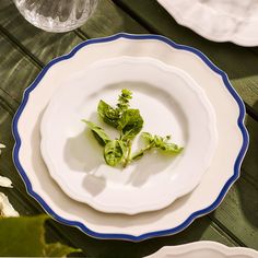 a plate with broccoli sprouts on it sitting on a wooden table