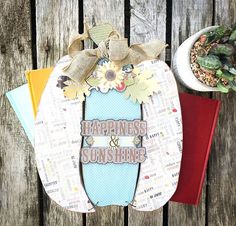 a wooden table topped with papers and flowers