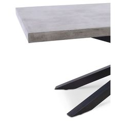 a concrete table sitting on top of a white floor next to two black metal legs