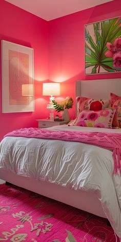 a bedroom with pink walls and white bedding in the center is decorated with flowers