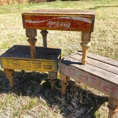 two wooden benches sitting on top of a grass covered field