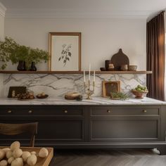 a dining room with marble counter tops and wooden chairs in front of the table is decorated with potted plants