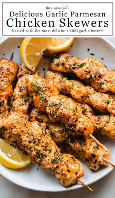 delicious garlic parmesan chicken skewers on a plate with lemon wedges