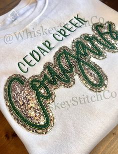 This listing is for an ADULT, SWEATSHIRT, **COUGARS** Sequin Embroidered 10 INCH Double Appliqué.  Other brand/style sweatshirts are available upon request There is an UPGRADE MY SWEATSHIRT listing Unisex sizing. These are MADE TO ORDER! COLORS/MATERIALS ARE COMPLETELY CUSTOMIZABLE.  OCCASIONALLY, SIZES/COLORS WILL SELL OUT, AND I HAVE TO USE A SUBSTITUTE BRAND. SHOULD THIS AFFECT YOUR ORDER, I WILL REACH OUT FOR THE BEST SOLUTION For any sizing recommendations please message me! Due to the nature of this item, I do not accept return or exchanges. HOWEVER, if there's an issue with your order, please contact me ASAP!! CARE: PLEASE PLEASE FOLLOW THESE CARE INSTRUCTIONS 💧 Machine wash cold, inside-out, gentle cycle with mild detergent and similar colors. *Mesh laundry bags are FANTASTIC for Cheerleading Tshirts Designs Ideas, Cheer Sweatshirt Ideas, Cute Sweatshirt Designs Cricut, Hoco 2023, Wild Lily, Cheerleading Tshirts, Rhinestone Sweatshirt, Cheer Team Gifts, Style Sweatshirts