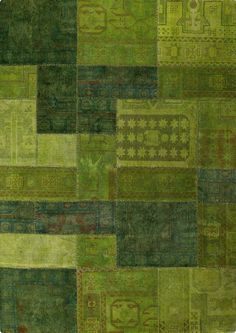 a patchwork rug with many different colors and patterns on it, including green tones