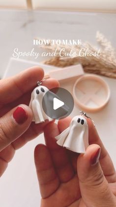 someone is holding two white ghost keychains in their hands with text overlay that reads how to make spooky and cute ghost key chains