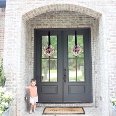 a baby standing in front of a black door with the words best 25 spanish from do