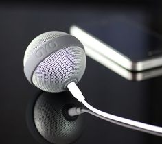 an electronic device with ear buds attached to it