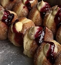 several doughnuts with blueberry filling in a box