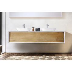 two white sinks sitting on top of a wooden counter