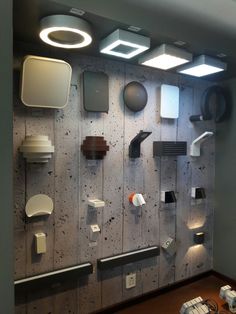 there are many different types of lights on the wall in this office space, including lamps and toilet paper