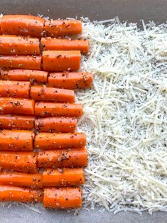 carrots and shredded parmesan cheese on a baking sheet ready to go into the oven