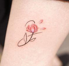 a woman's leg with a flower tattoo on her left thigh and the word love written in cursive writing