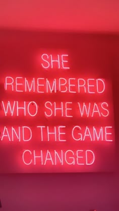 a neon sign with the words she remembers who she was and the game changed on it