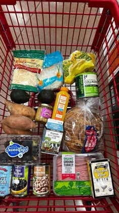 a shopping cart filled with groceries and food