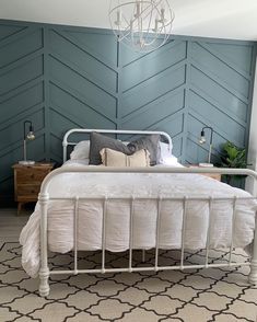 a white bed sitting in a bedroom on top of a rug