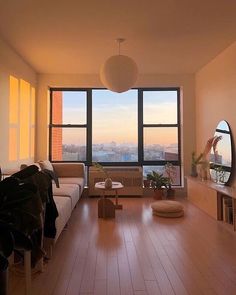 a living room filled with furniture and large windows