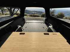 the back end of a truck with two tables in it