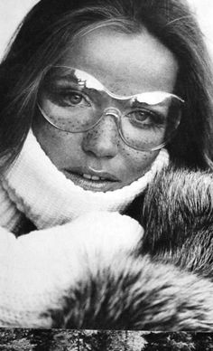 an old photo of a woman wearing glasses and a fur coat with her eyes closed