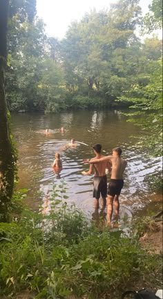 several people are wading in the river together