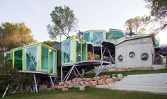 there are many green and yellow containers stacked on top of each other in the grass