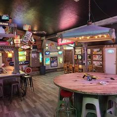 the inside of a restaurant with wooden tables and stools