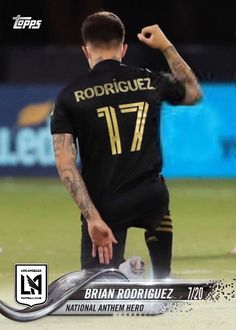 the soccer player is celebrating his team's victory in front of an advert