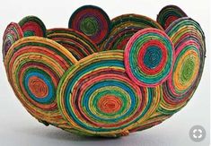 a bowl made out of multicolored paper