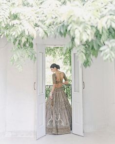 a woman is standing in an open doorway