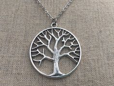 "Here is a simple and chic silver tree pendant necklace. It is timeless and versatile. Perfect for everyday, year round wear. This would make a very thoughtful gift as well. The round tree measures 1 3/8\" long by 1 1/4\" wide and hangs from a simple 18\" stainless steel necklace chain. I have matching earrings in my shop, if you would like the whole set. Here is the link https://etsy.me/2nHHl1x Thanks for stopping by! Please take a moment and visit the rest of my Etsy shop. I have many more uni Poison Tree, Tree Of Life Necklace Silver, Sterling Silver Tree Of Life Nature-inspired Jewelry, Sterling Silver Tree Of Life Round Pendant Necklace, Unique Sterling Silver Tree Of Life Necklace, Spiritual Tree Of Life Sterling Silver Necklace, Tree Of Life Earrings, Tree Of Life Jewelry, Tree Necklace