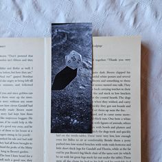 an open book with a black and white image of a dice on the page next to it