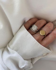 a woman's hand wearing a gold and diamond ring